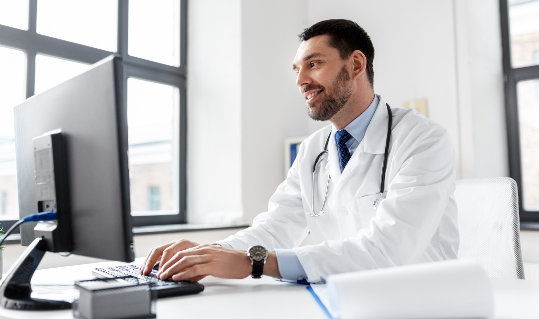 Provider sitting at a desk looking at a computer monitor